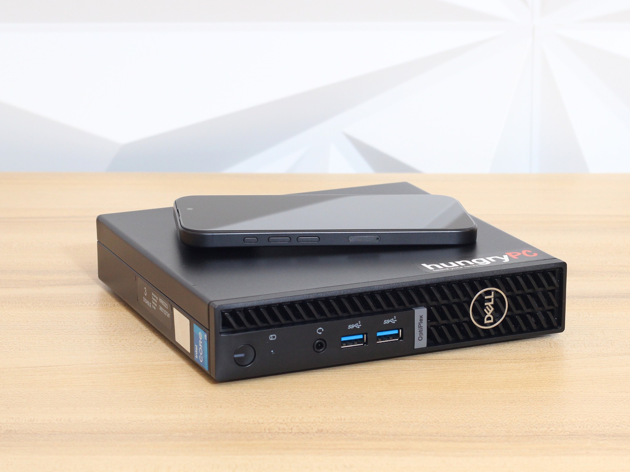 Dell OptiPlex Micro 7010 Mini PC iphone for scale size comparison: refurbished dell optiplex 7010 mini pc shown next to an iphone to demonstrate its footprint.