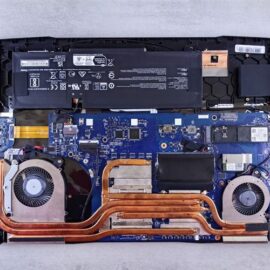 Inside a modern business laptop during refurbishment in NZ, showing the NVMe SSD, battery and cooling system