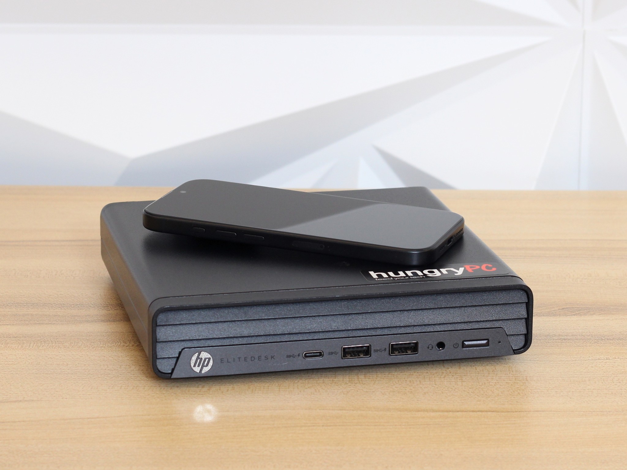 HP EliteDesk 805 G6 Desktop Mini PC iPhone for Scale size comparison: refurbished hp elitedesk 805 g6 mini pc shown next to an iphone to demonstrate its footprint.
